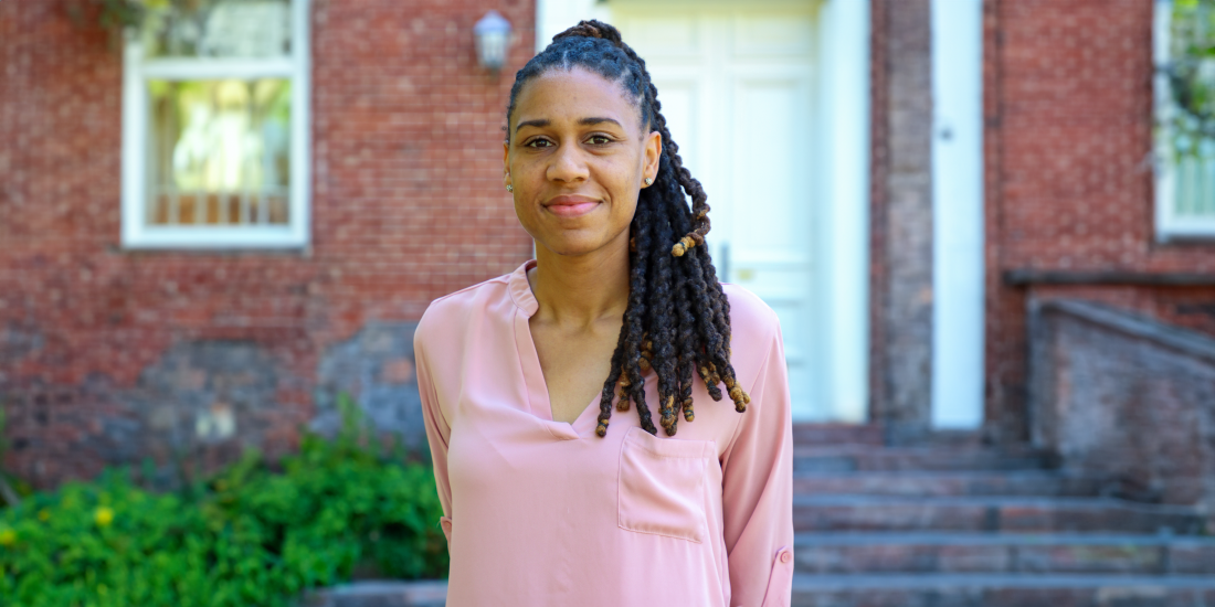 A picture of Dr. Donelle Boose in front of a brick building at Randolph-Macon College.