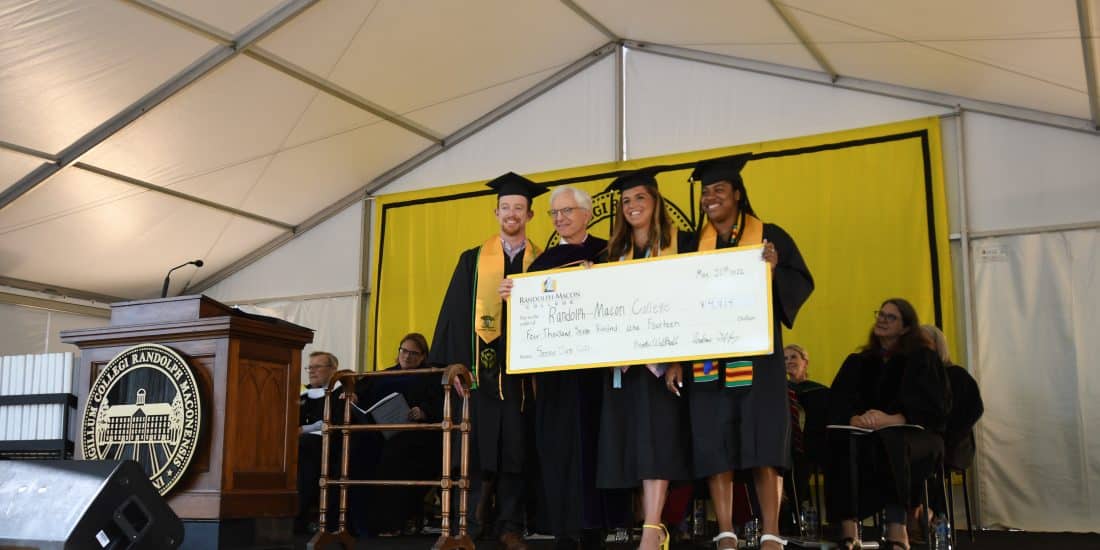 President Lindgren with Randolph-Macon graduates holding a big check.