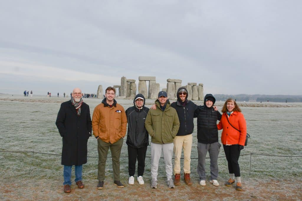 A group of students standing in front of stonehenge