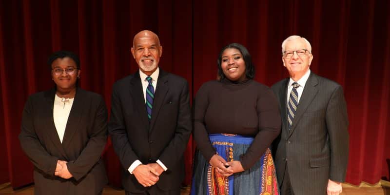 Antonette Parish '26, Judge Robert L Gregory, Linae Branch, and President Lindgren standing on stage in blackwell auditorium