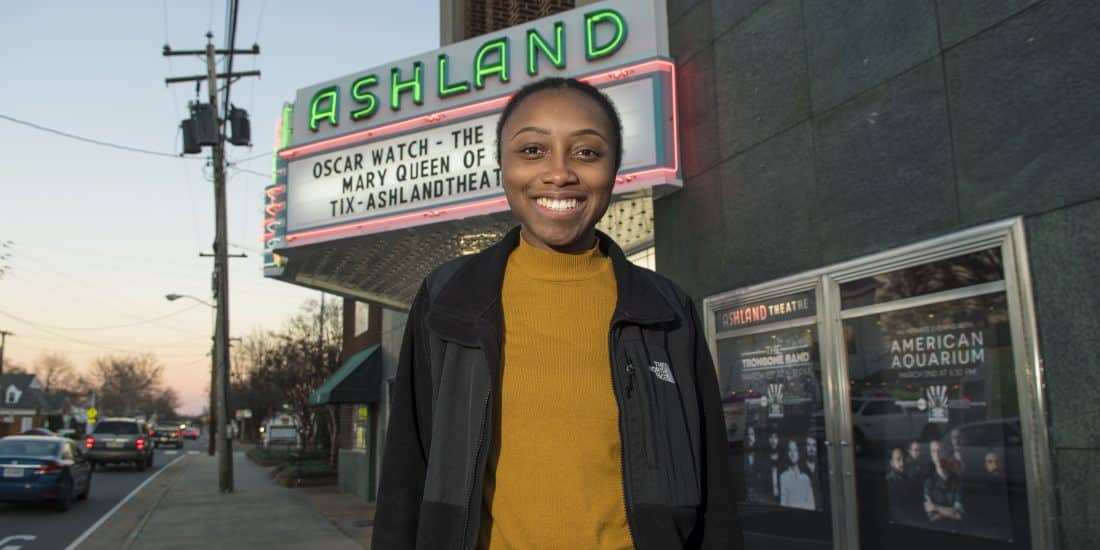 A RMC student poses outside the Ashland Theater where they interned