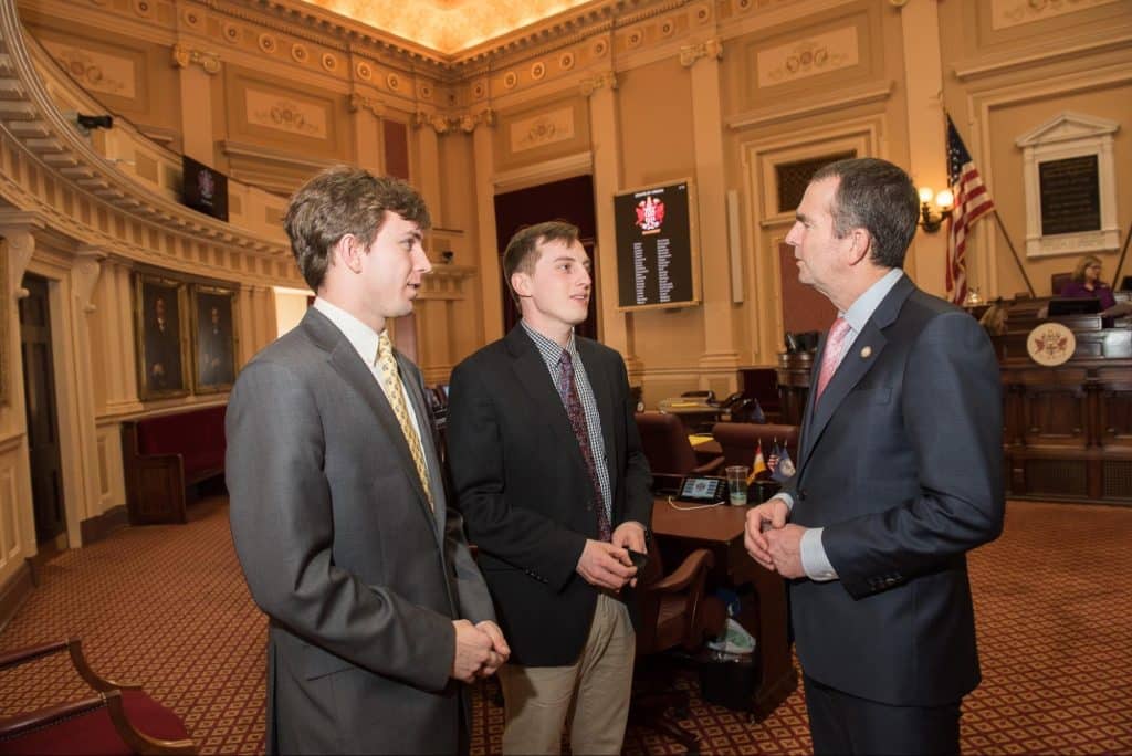 Two pre-law students speak with a law maker