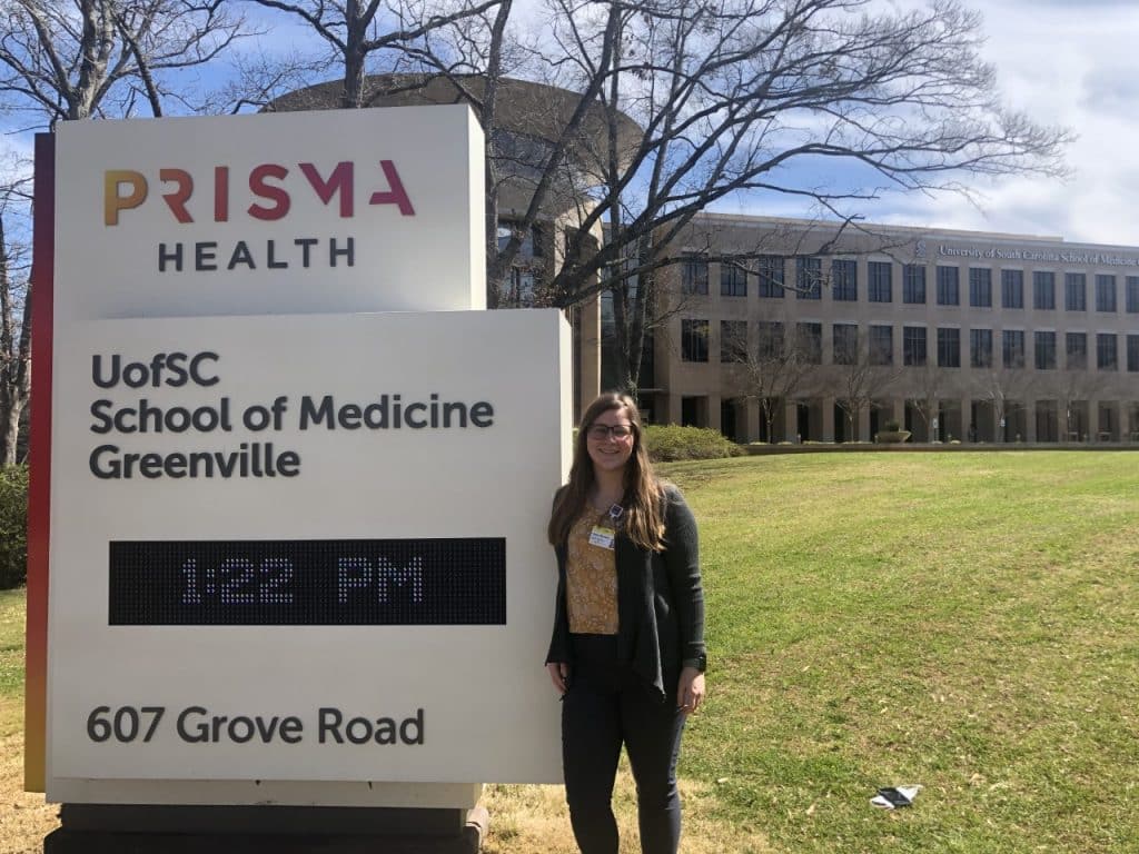 RMC student standing in front of U of SC School of Medicine Greenville sign