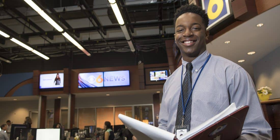A RMC student poses for a photo while interning at the CBS 6 studio.