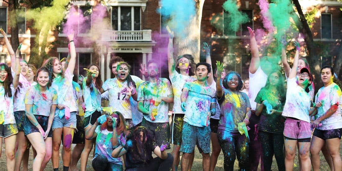 students with colorful chalk Holi