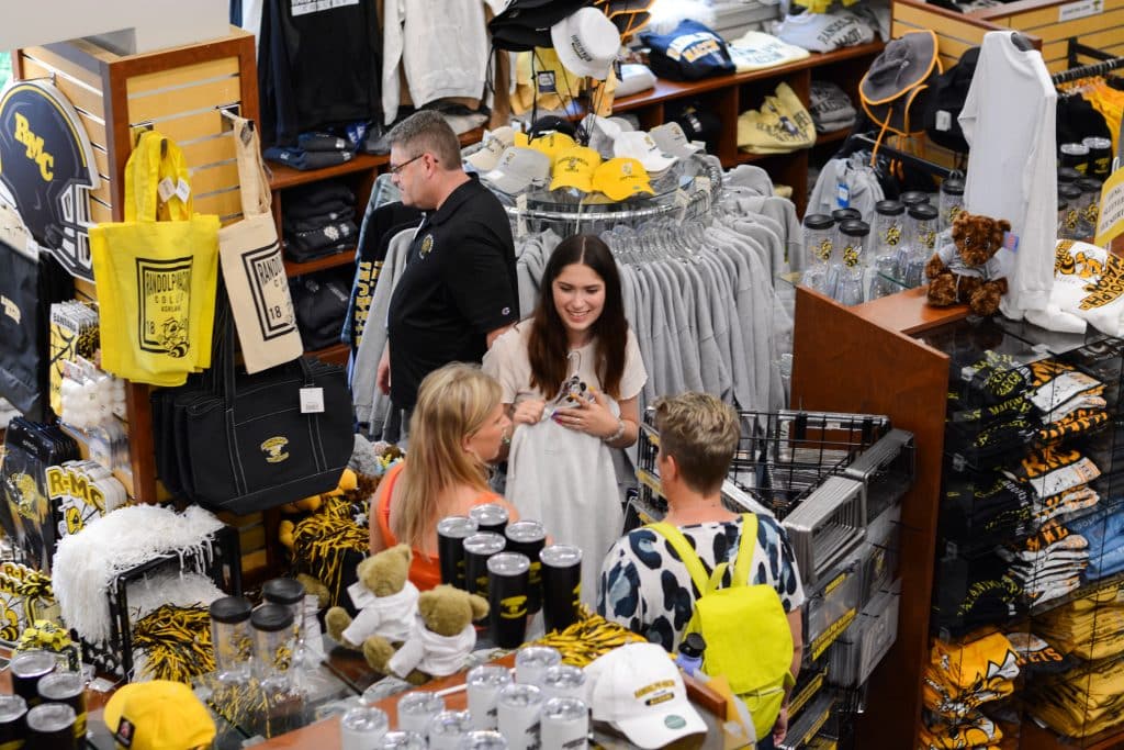A group of admitted students looking at merchandise in a store.