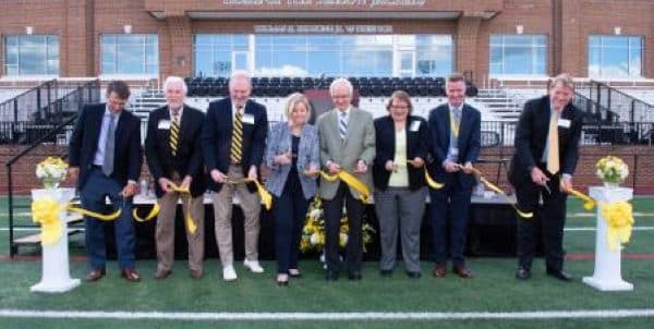 Representatives from Randolph-Macon's administration and Board of Trustees cut the ribbon in front of Duke Hall