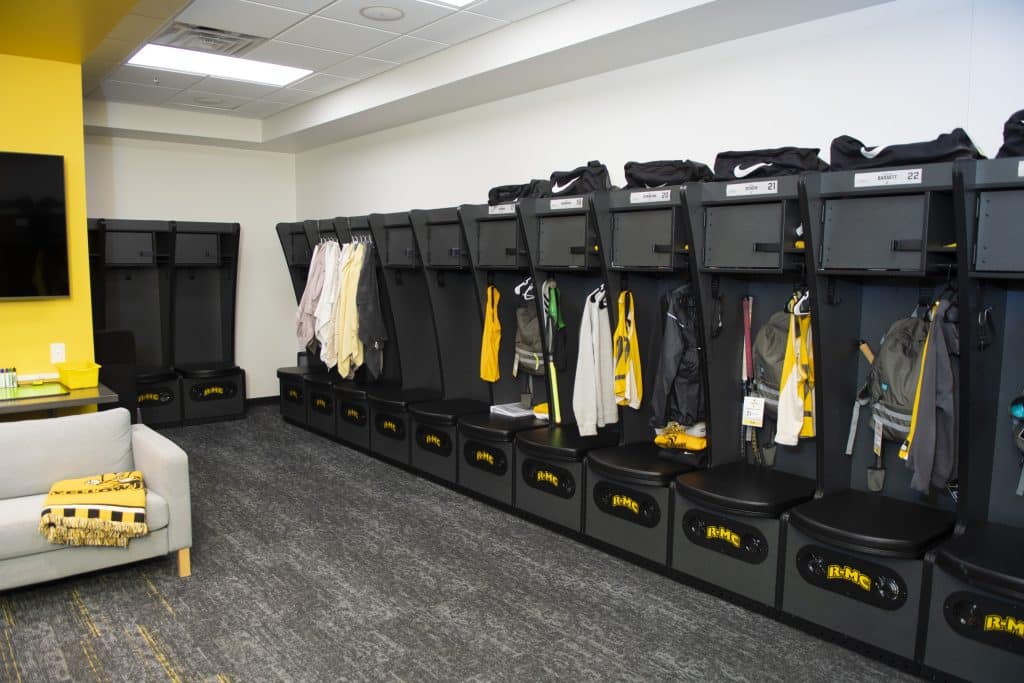 A locker room in Duke Hall that is decorated in lemon yellow and black 