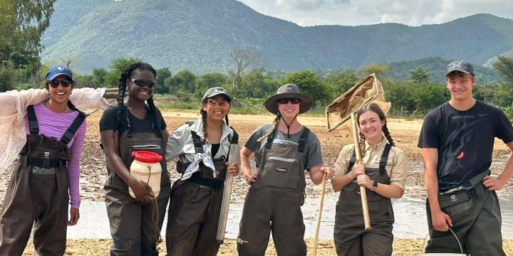 Student researchers pose with equipment used to collect species of fishes and macroinvertebrates in Kenya