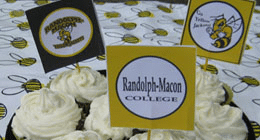 Cupcakes with bees on them are on a plate at a fall tailgating party.