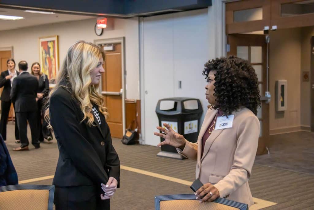 Joy Asekun speaks with a student at the Edge Boot Camp