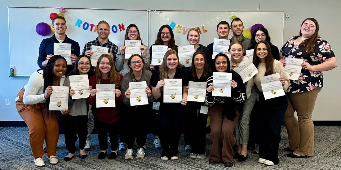 The inaugural class of PA students poses with their assignments for their first clinical rotation