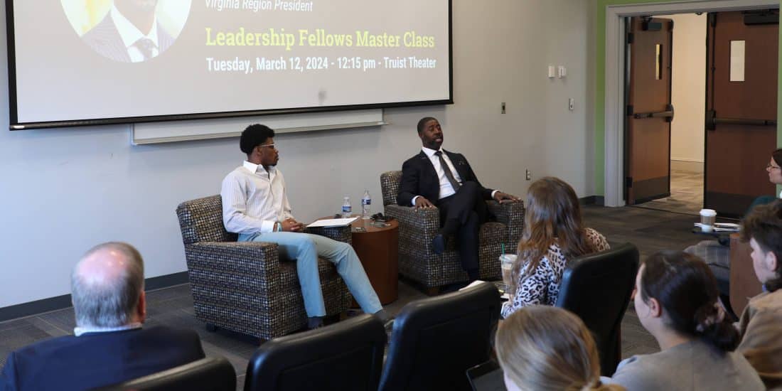 Two individuals leading a discussion in front of an audience at a leadership fellows master class event.